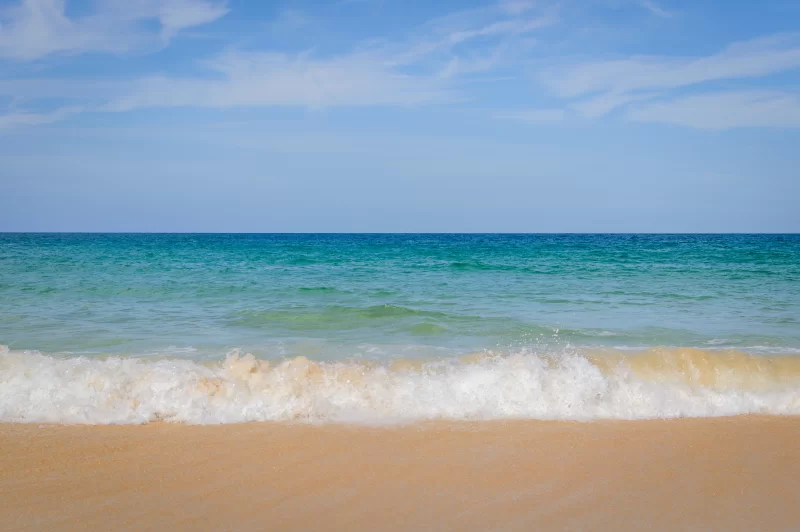 Сцена спокойного пляжа с ясным голубым морем