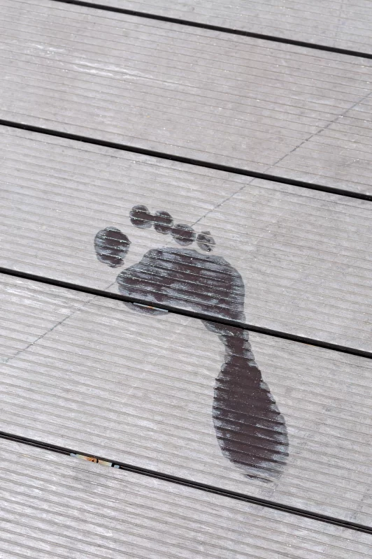 Footprint on wooden planks: symbol of journey and human traces