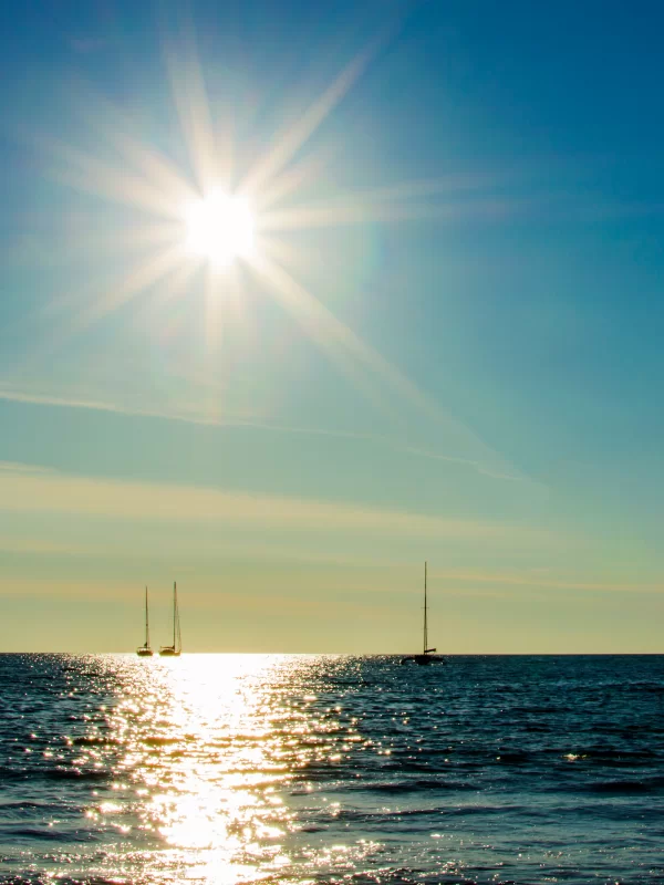 Sailboats at Sunset over Calm Sea