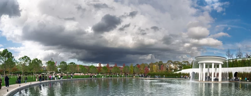 Парк с фонтаном и прудом, люди гуляют