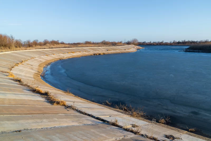 Замерзший речной берег с бетонным откосом