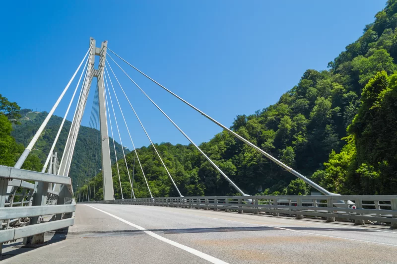Modern suspension bridge over mountain valley