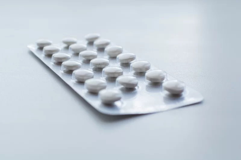 Blister pack with white pills on a light background