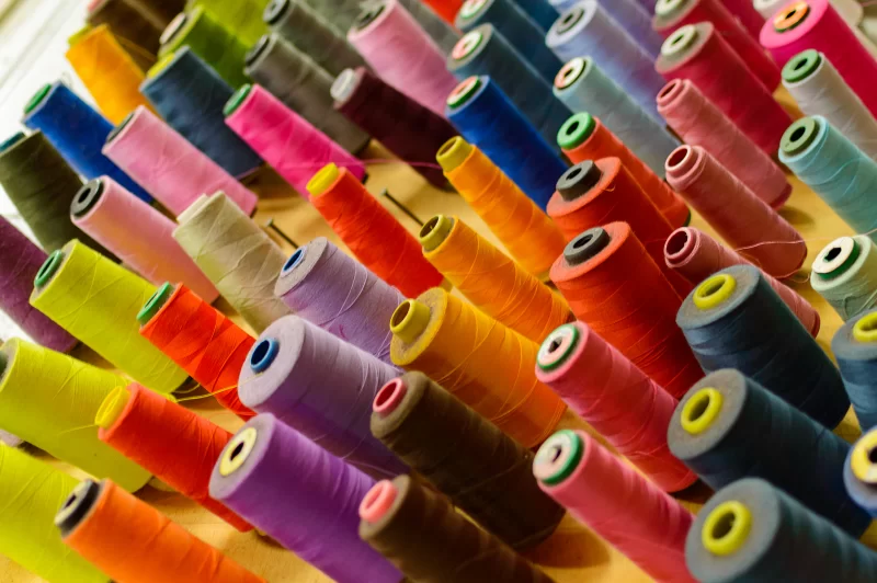 Colorful spools of thread in a sewing workshop