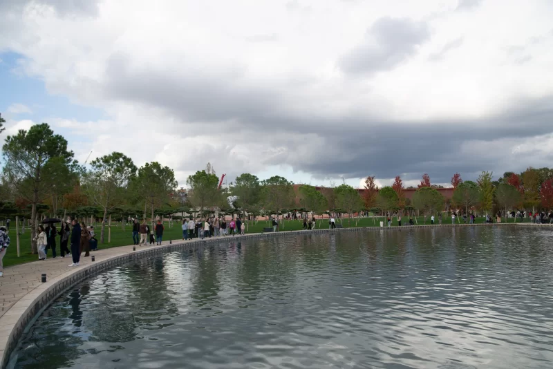 Park with pond and people on an autumn day
