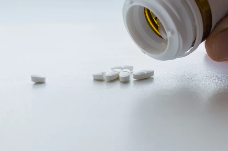 White pills spilling out of a bottle