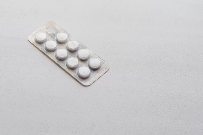 Blister pack of white pills on a white background