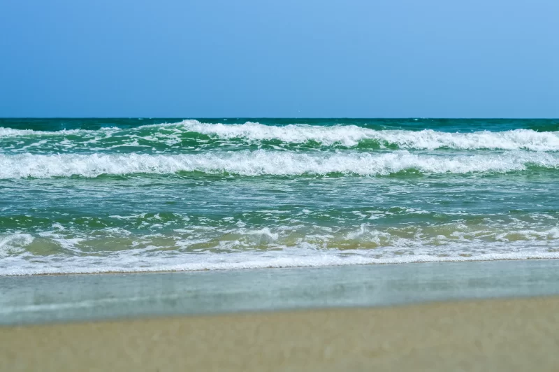 Мягкие волны моря с пеной на песчаном пляже