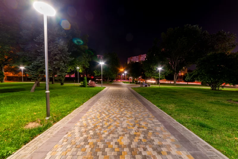 Beautiful city park walkway with lamps at night