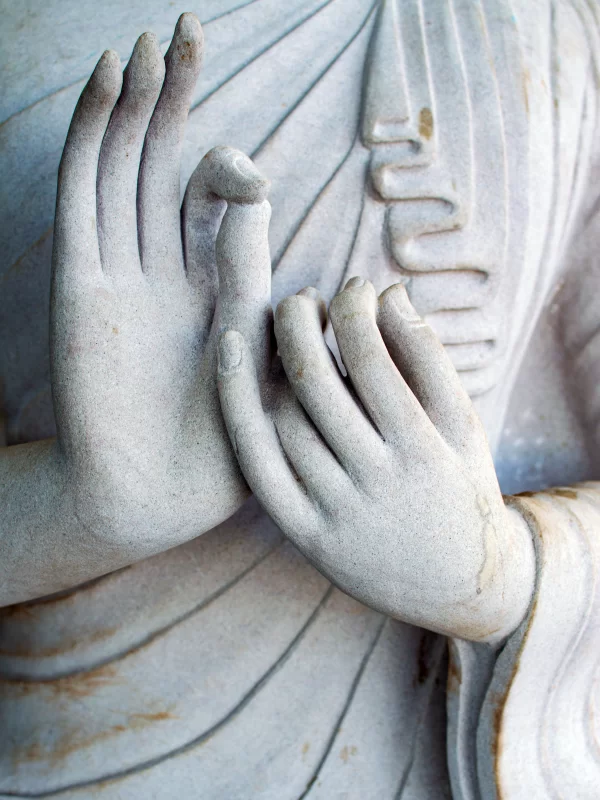 Detailed sculpture of Buddha's hands in prayer position