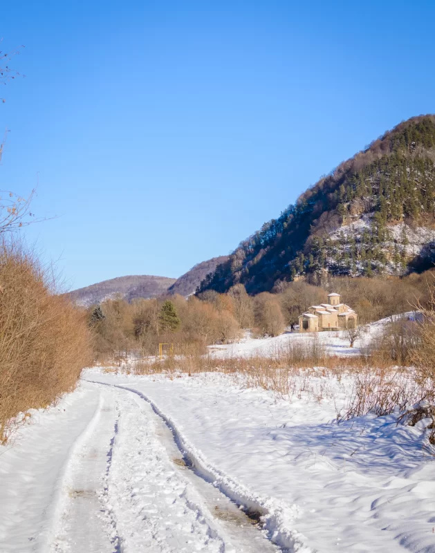 Winter road to an ancient church in the mountains